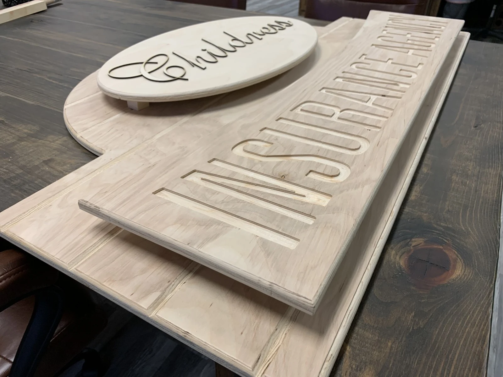 Unfinished sign showing its layered panels and lettering