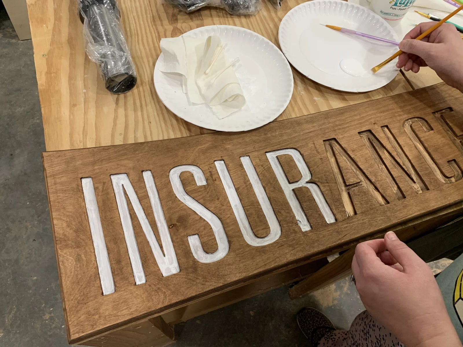 White business lettering being finished by hand