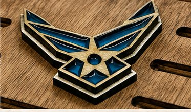 Close-up of the layered blue and silver Air Force emblem on a coin holder
